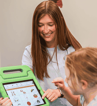 Therapist guiding a child through a sensory activity at South Shore Therapies 